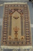 A small Persian style prayer rug 110cm x 74cm.