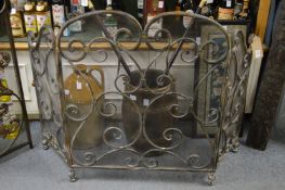 An ornate folding fire screen.