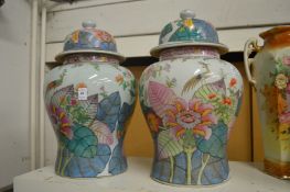 A pair of large Chinese temple jars and covers.