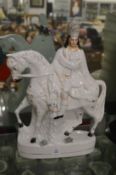 A Staffordshire flatback figure of a man on a horse.