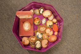 A quantity of cameo brooches and lockets.