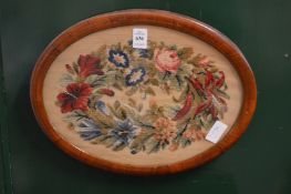 A Victorian wool work oval panel, framed and glazed.