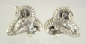 A PAIR OF SILVER RUBY EYED RAMS HEAD CUFFLINKS.