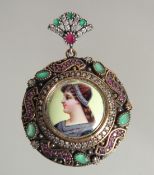 A SILVER AND GILT ENAMEL PENDANT.