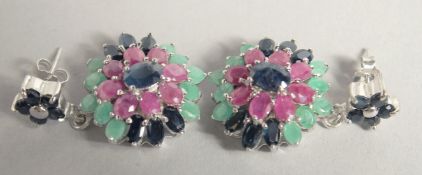 A PAIR OF SILVER RUBY SAPPHIRE AND EMERALD CLUSTER EARRINGS.
