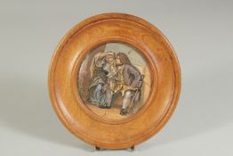 A PORCELAIN POT LID, UNCLE TOBY, 4ins diameter, framed.