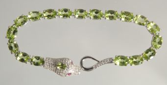 A SILVER PERIDOT SET SNAKE BANGLE.