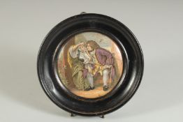 A PORCELAIN POT LID, UNCLE TOBY, 4ins diameter, framed.