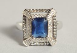 A SILVER DECO STYLE RING WITH CUBIC ZIRCONIA AND SAPPHIRE.