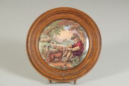 A PORCELAIN POT LID, THE SHEPHERD BOY, 4ins diameter, framed.