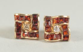 A PAIR OF 9CT. GOLD GARNET EAR STUDS.