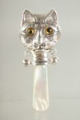 A SILVER AND MOTHER OF PEARL CAT FACE RATTLE.