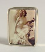 A SILVER AND ENAMEL NUDE PILL BOX, 1.25