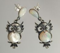 A PAIR OF SILVER AND MOTHER OF PEARL OWL EARRINGS.