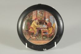 A PAIR OF PORCELAIN POT LIDS, 3.5ins diameter. Framed, chips to base