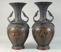 AN EXCEPTIONAL PAIR OF JAPANESE BRONZE SAMURAI VASES, the panel on each with relief samurai