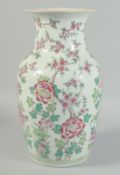 A CHINESE FAMILLE ROSE PORCELAIN VASE, painted with native flora, 36.5cm high.