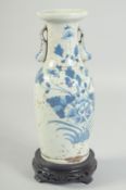 A 19TH CENTURY QING DYNASTY CHINESE BLUE AND WHITE TWIN HANDLE VASE, with hardwood stand, vase 23.