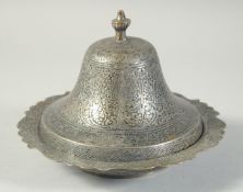 AN ISLAMIC ENGRAVED DISH AND COVER, with foliate decoration, 19.5cm wide.