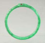 A JADEITE SNAKE-FORM BRACELET with inset ruby eyes, 7cm diameter.