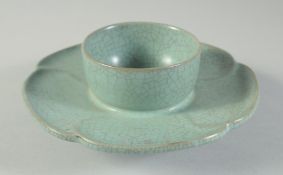 A CHINESE CELADON CRACKLE GLAZE TEA CUP STAND, with petal form rim and incised characters, 17cm