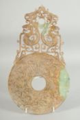 A SUPERB LARGE JADE DISK, with relief and pierced decoration depicting dragons, 34.5cm x 19.5cm.