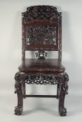 A 19TH CENTURY CHINESE CARVED HARDWOOD CHAIR, the back rest carved and pierced with dragons and