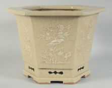 A 19TH CENTURY CHINESE CELADON CRACKLE GLAZE HEXAGONAL FLOWER POT, decorated with floral panels,