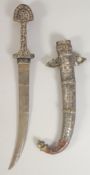 AN ISLAMIC SILVER INLAID DAGGER AND SCABBARD, 40cm long.