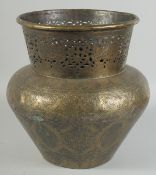 AN ISLAMIC ENGRAVED BRASS VASE, with openwork collar and panels of calligraphy, 29.5cm high.