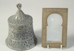 A SMALL EMBOSSED METAL MIRROR, together with another Islamic engraved metal item, (2)