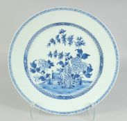 A CHINESE BLUE AND WHITE PORCELAIN CHARGER, painted with central panel of native flora, 38.5cm