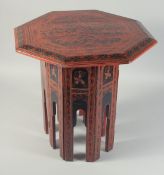 AN ORIENTAL RED AND BLACK LACQUERED WOOD TABLE.