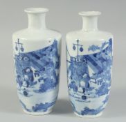 A FINE PAIR OF CHINESE KANGXI BLUE AND WHITE PORCELAIN VASES, each painted with a mirrored scene