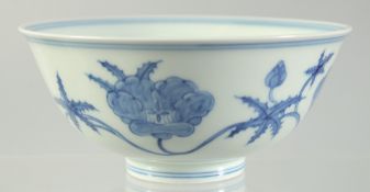 A CHINESE BLUE AND WHITE PORCELAIN BOWL, painted with flower heads, six-character mark to base, 15cm