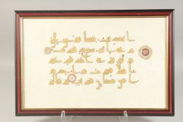 A 20TH CENTURY KUFIC CALLIGRAPHIC PANEL ON PAPER, mounted and framed, panel 31cm x 49cm.