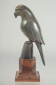 A CARVED HORN FIGURE OF A PARROT, mounted to a wooden base, 18.5cm high.