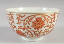 A CHINESE RED AND WHITE PORCELAIN BOWL, with floral motifs and gilt highlights, the base with four-