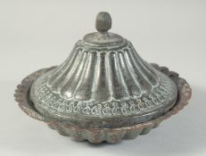 AN ISLAMIC TINNED COPPER DISH AND COVER, 21cm diameter.
