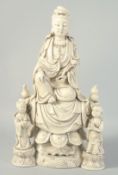 A LARGE BLANC-DE-CHINE GUANYIN AND CHILDREN, 46.5cm high.