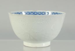 A SMALL CHINESE BLUE AND WHITE BOWL, the exterior with carved decoration, (faults) 9cm.