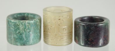 THREE ARCHER'S RINGS; one jade and two hardstone, (3).