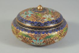A CLOISONNE PART-ENAMELLED GILT CIRCULAR LIDDED BOX, with raised floral decoration, 15cm diameter.