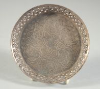 A SMALL ENGRAVED ISLAMIC DISH, with calligraphy, 10cm diameter.