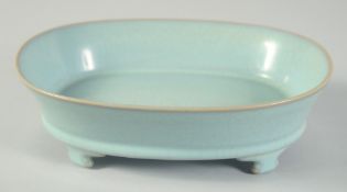 A CHINESE CELADON CRACKLE GLAZE PLANTER, raised on four feet, 22.5cm x 17cm.