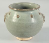 A CHINESE CELADON GLAZE POTTERY JAR, with molded lion mask handles and a band of raised bosses, 13.