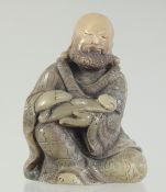 A CHINESE CARVED SOAPSTONE LUOHAN FIGURE AND STAND, the figure 8.5cm high.