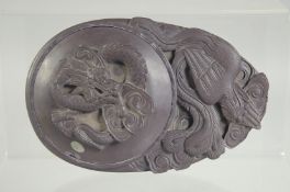 A 19TH CENTURY CHINESE CARVED INKSTONE CALLIGRAPHY INKWELL, carved with dragon and phoenix, 16.5cm x