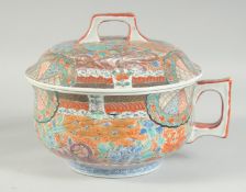 A JAPANESE KUTANI CHAMBER POT AND COVER, painted with exotic birds and flora, 26cm wide (including