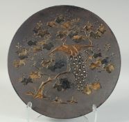 A JAPANESE CAST IRON CHARGER, with mixed metal decoration of a peacock and foliage, 39cm diameter.